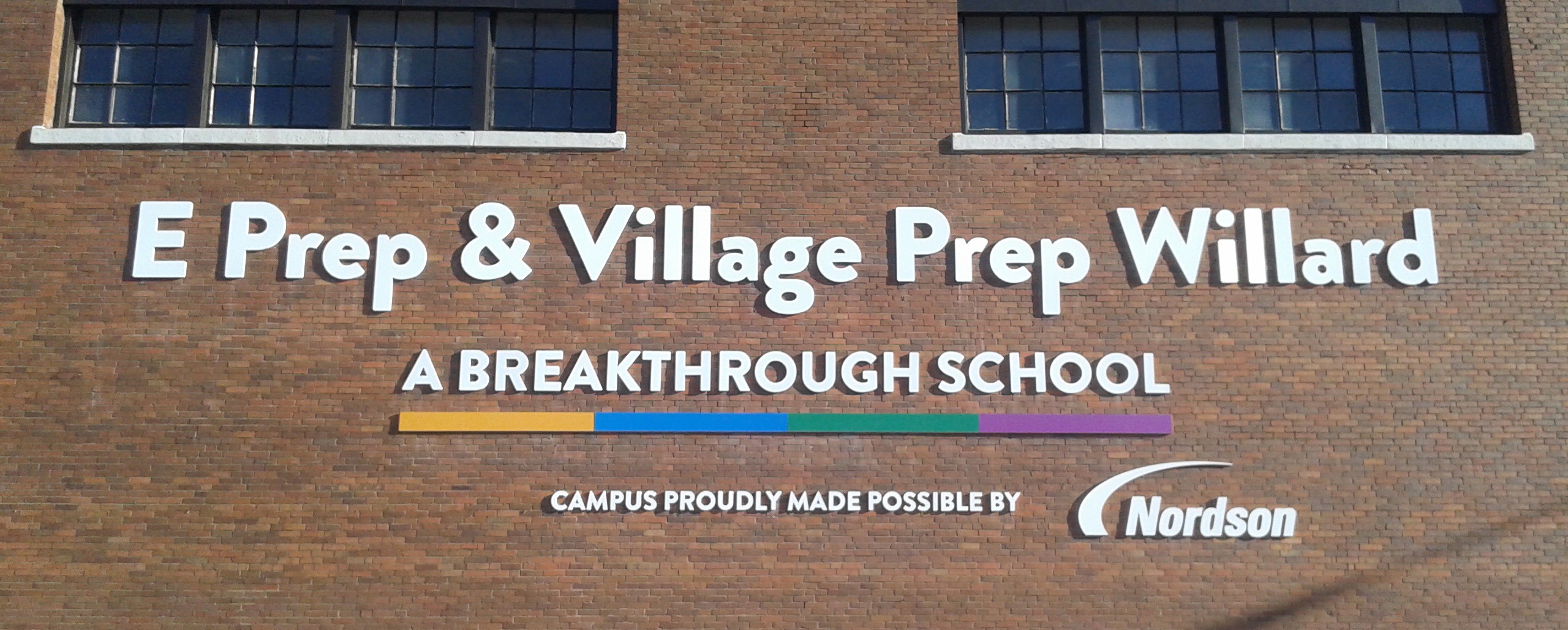 Outdoor school campus sign created by our wide format department and installed on the building by Consolidated Solutions - Portfolio Corporate Signage