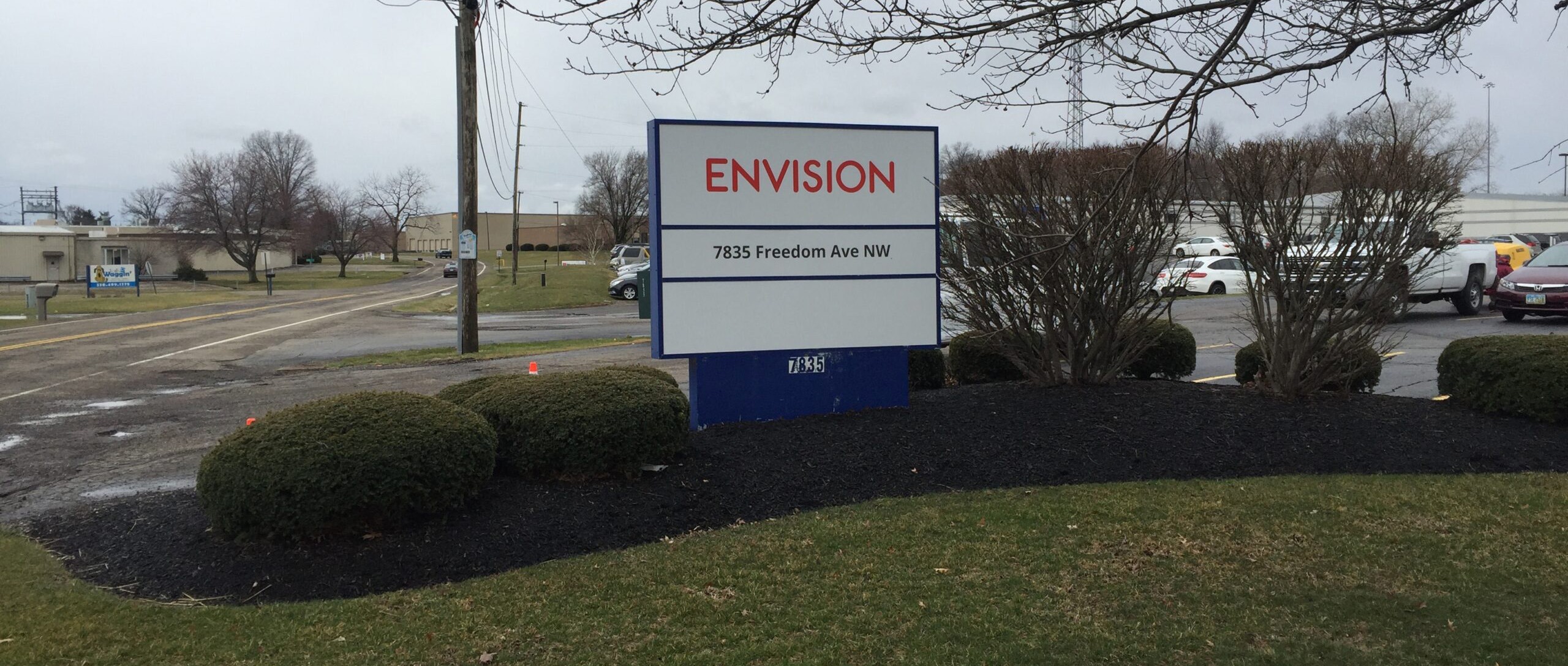 Envision Outdoor Company Sign in front of parking lot.