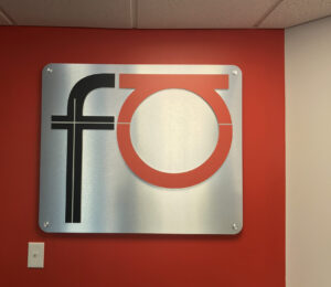 Custom Company logo created on metal sign installed with standoff's to provide a dimensional feel.